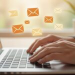 Person typing an email newsletter on a laptop, representing how to build an engaged email list through authentic communication